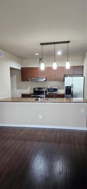 1100 West Trinity Mills Road, Unit 3003 Carrollton, TX 75006 - Photo 11 of 26 a view of kitchen with stainless steel appliances wooden floor