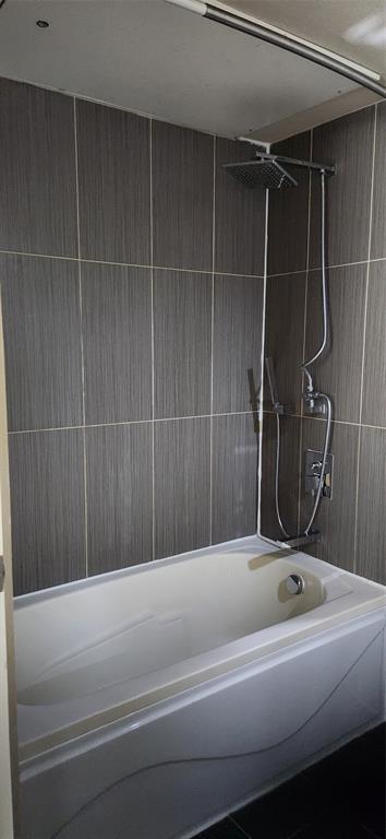 1100 West Trinity Mills Road, Unit 3003 Carrollton, TX 75006 - Photo 20 of 26 a bathroom with a bathtub and a shower