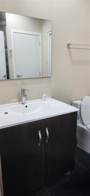 1100 West Trinity Mills Road, Unit 3003 Carrollton, TX 75006 - Photo 23 of 26 a bathroom with a sink and a mirror