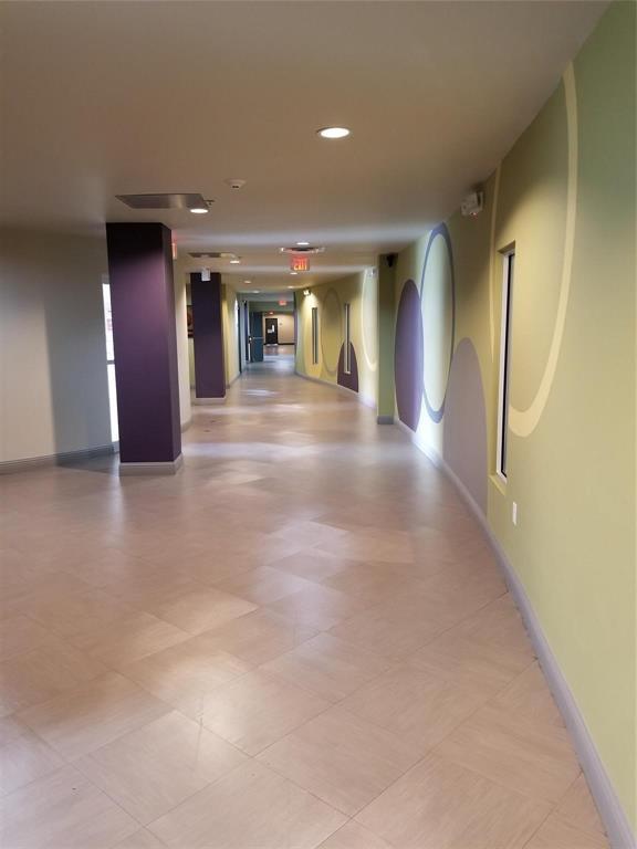 1100 West Trinity Mills Road, Unit 3003 Carrollton, TX 75006 - Photo 4 of 9 Hallway featuring baseboards and recessed lighting