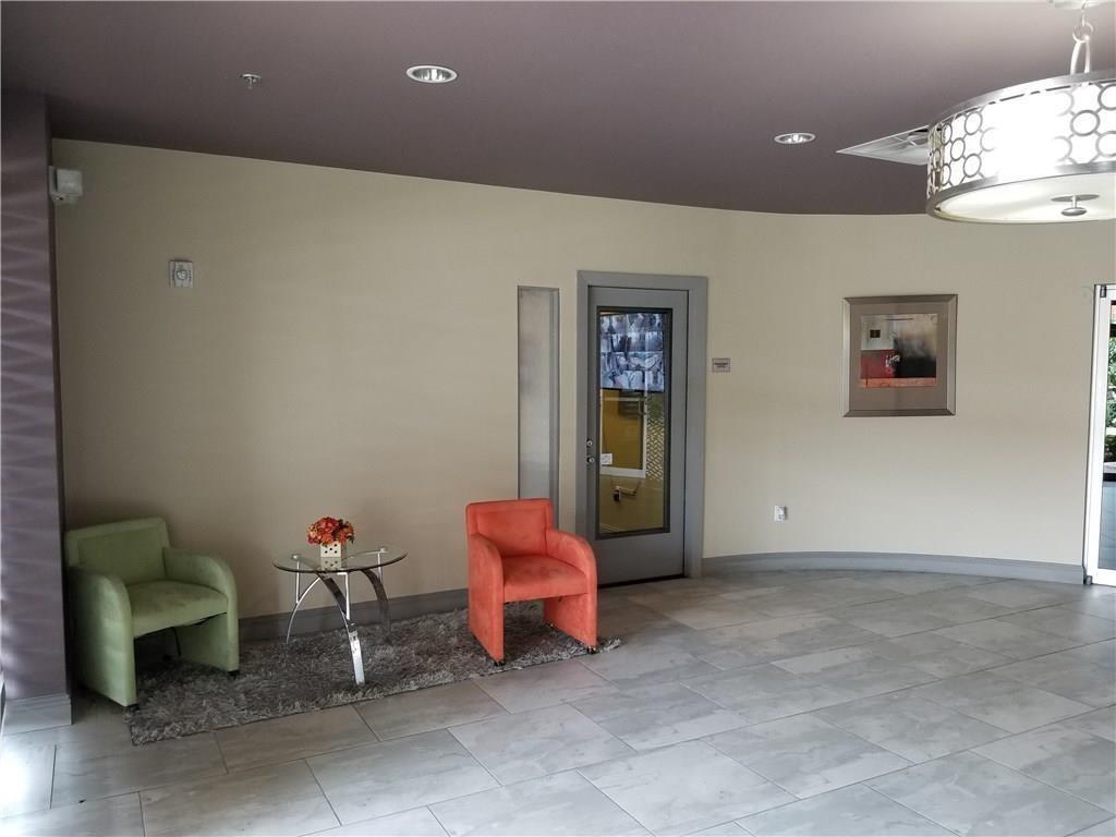 1100 West Trinity Mills Road, Unit 3003 Carrollton, TX 75006 - Photo 5 of 9 Lounge area featuring baseboards and recessed lighting