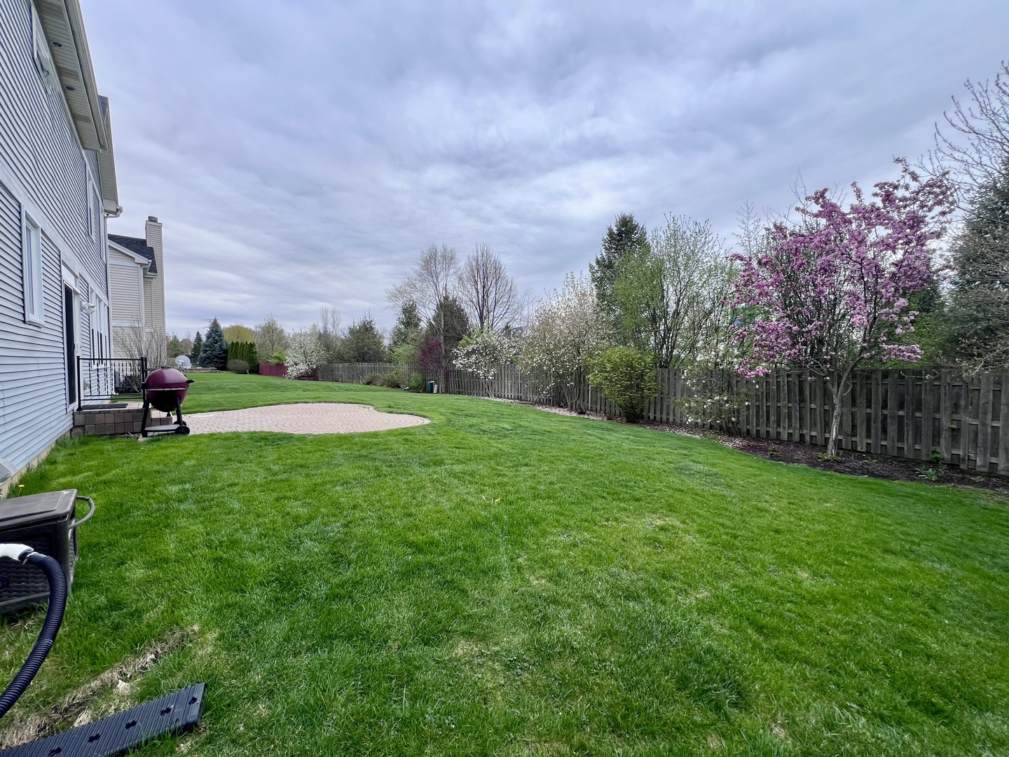 407 Post Oak Circle West Chicago, IL 60185 - Photo 23 of 23 a view of a park with large trees and a wooden fence