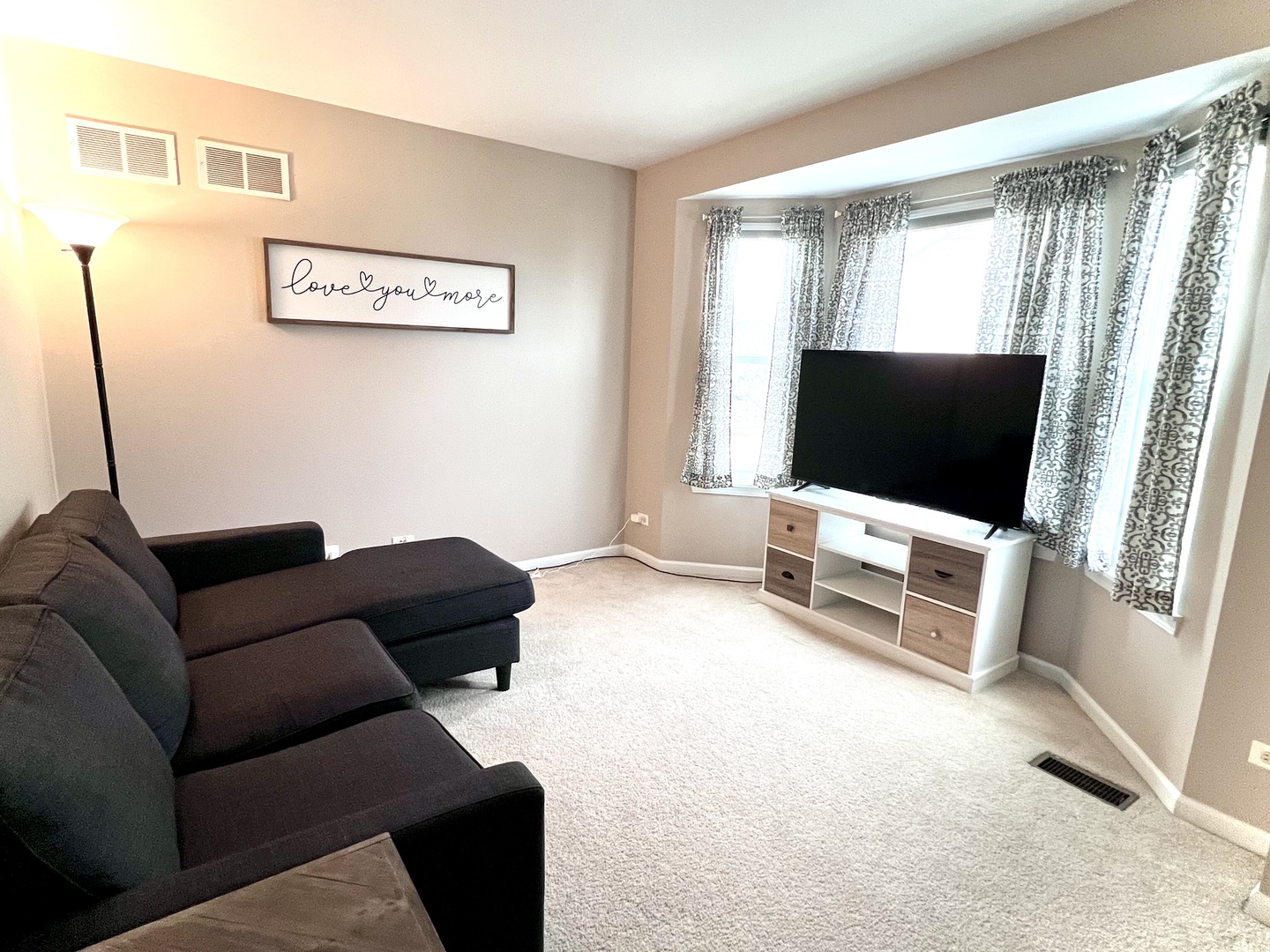 407 Post Oak Circle West Chicago, IL 60185 - Photo 9 of 23 a living room with furniture and a flat screen tv