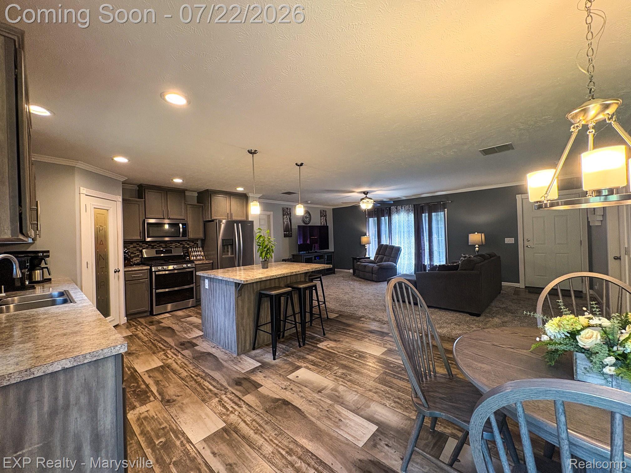 2601 Beach Road Port Huron, MI 48060 - Photo 11 of 34 Open-concept living space featuring wood-finish flooring, recessed lighting, and stainless steel appliances