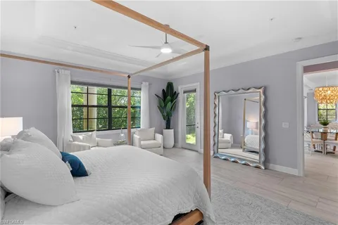 a large bedroom with a large bed and a large window