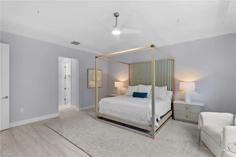 a bedroom with a bed and a lamp