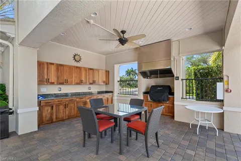 a kitchen with a table chairs stove and cabinets