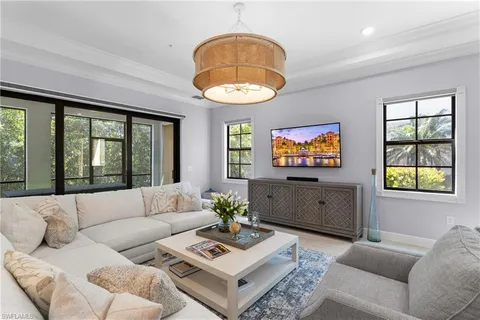 a living room with furniture a table and a large window