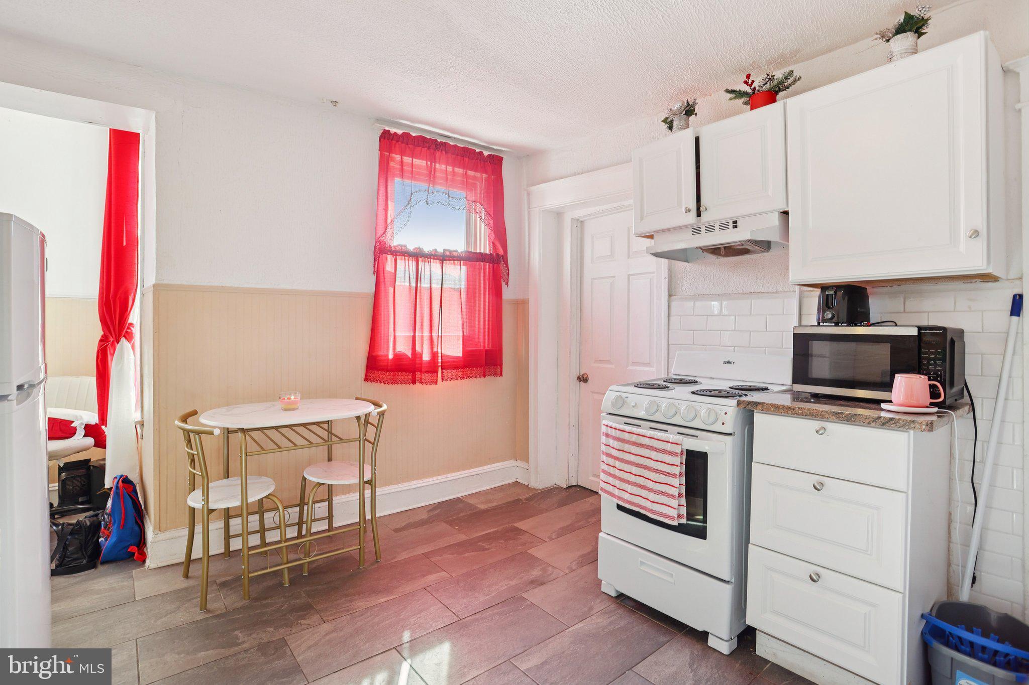 1540 Adams Avenue Philadelphia, PA 19124 - Photo 17 of 43 a kitchen that has a lot of cabinets and a wooden floor