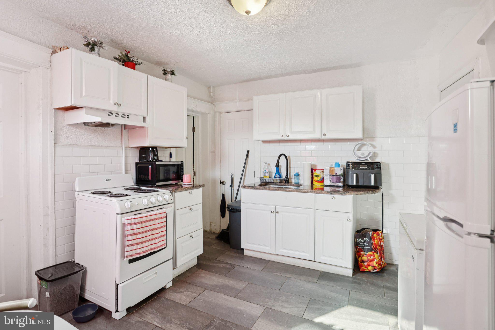 1540 Adams Avenue Philadelphia, PA 19124 - Photo 18 of 43 a kitchen with a stove and a refrigerator