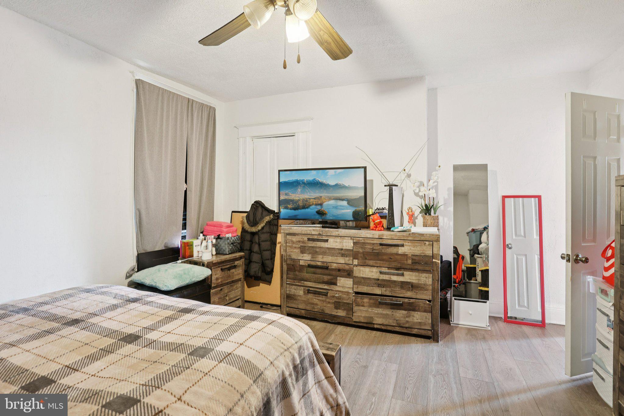 1540 Adams Avenue Philadelphia, PA 19124 - Photo 20 of 43 a bedroom with a bed and a chandelier