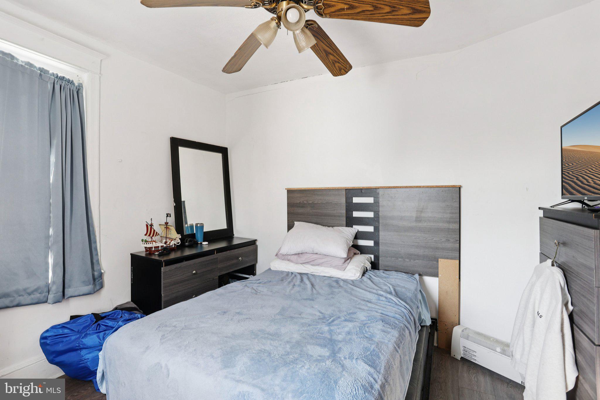 1540 Adams Avenue Philadelphia, PA 19124 - Photo 22 of 43 a bedroom with a bed and a flat tv screen on a dresser