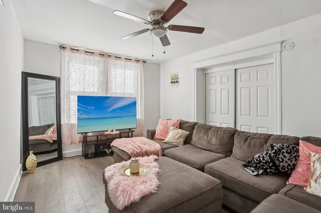 a living room with furniture ceiling fan and a rug
