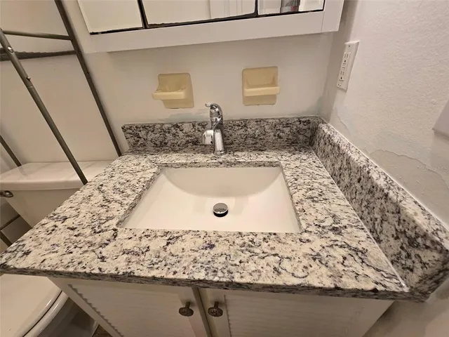 a view of kitchen with a large window and sitting area