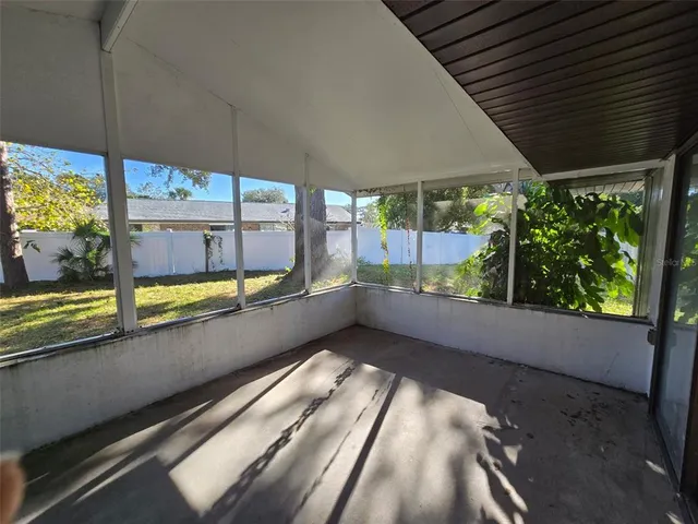 a backyard of a house with table and sofas