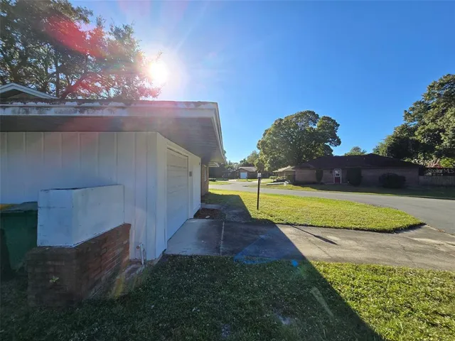 a view of a house with backyard and sitting area