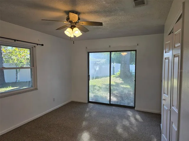 a bathroom with a granite countertop sink mirror vanity and toilet