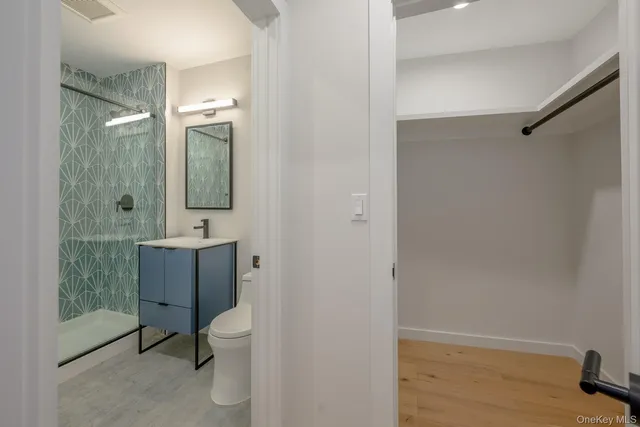 a bathroom with a toilet a sink and shower