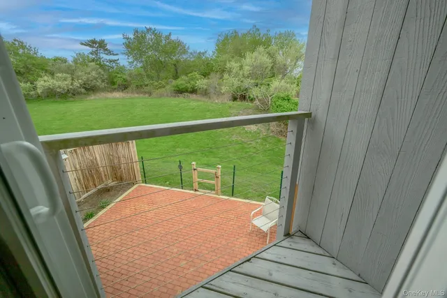 a view of balcony with yard