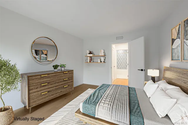 a bedroom with a bed and a painting on the wall