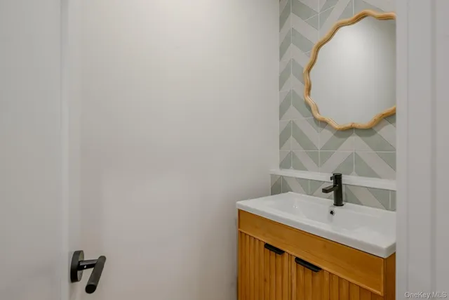 a bathroom with a sink and mirror