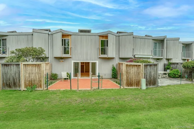 a view of a backyard with table and chairs and potted plants