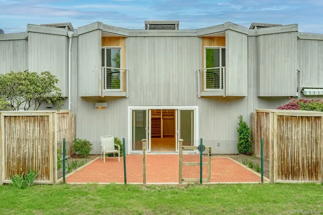 a view of small house with backyard