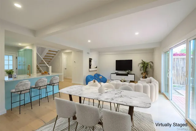 a living room with furniture a flat screen tv and a table