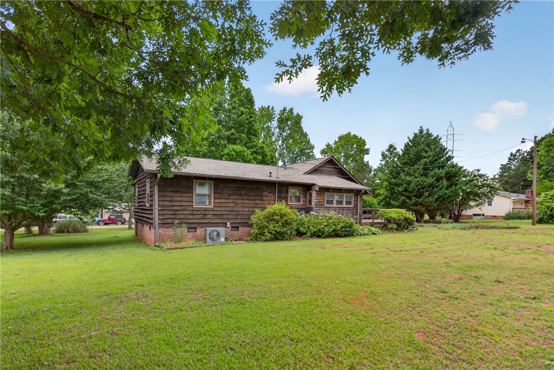 112 Holliday Lane Pendleton, SC 29670 - Photo 38 of 42 A charming wood-sided residence nestled amidst verdant landscaping.