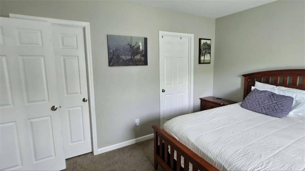 2956 Westmoreland Road Cleveland, GA 30528 - Photo 13 of 22 a bedroom with a bed and a walk in closet