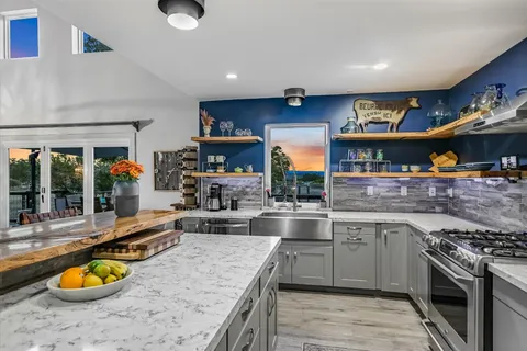 a view of a chair and table on the deck
