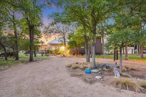 a floor to ceiling window next to a yard