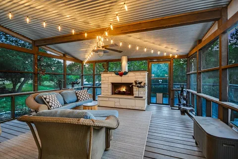 a kitchen with stainless steel appliances granite countertop a table chairs sink and cabinets