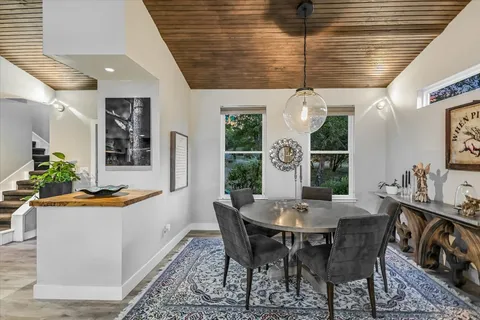 a spacious bedroom with a bed a couch and window