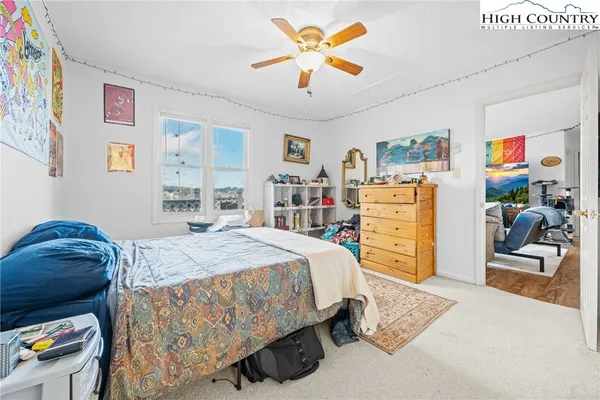 a bedroom with a bed and dresser