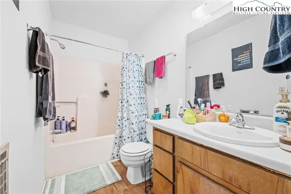 a bathroom with a sink vanity mirror and toilet