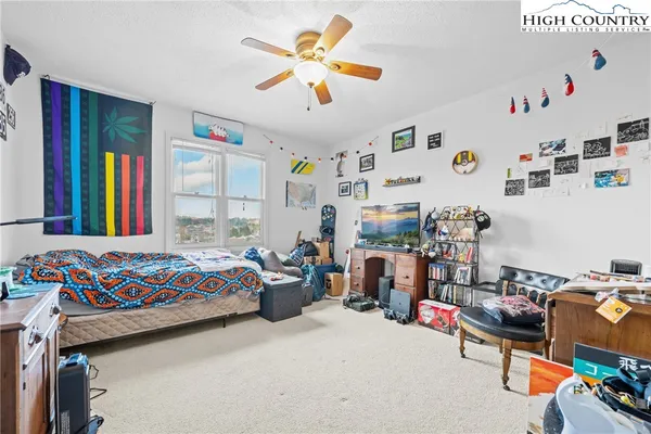 a bedroom with bed and a window