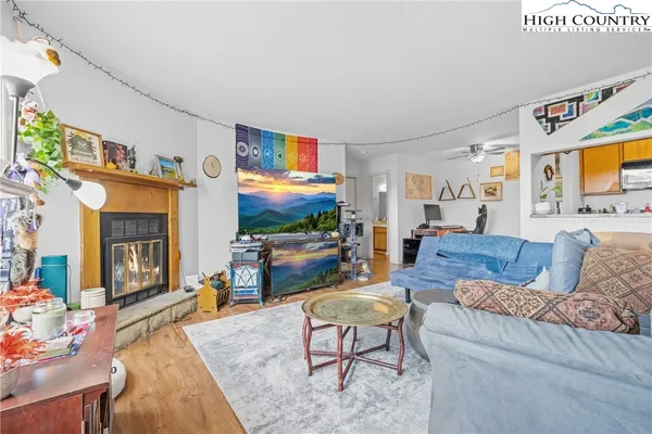 a living room with furniture a flat screen tv and a dining table