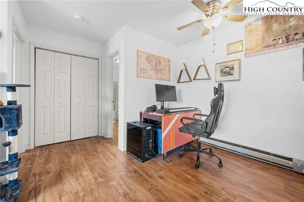 a view of a workspace with furniture and wooden floor
