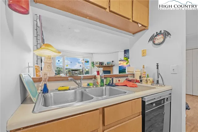 a kitchen with a sink and a refrigerator