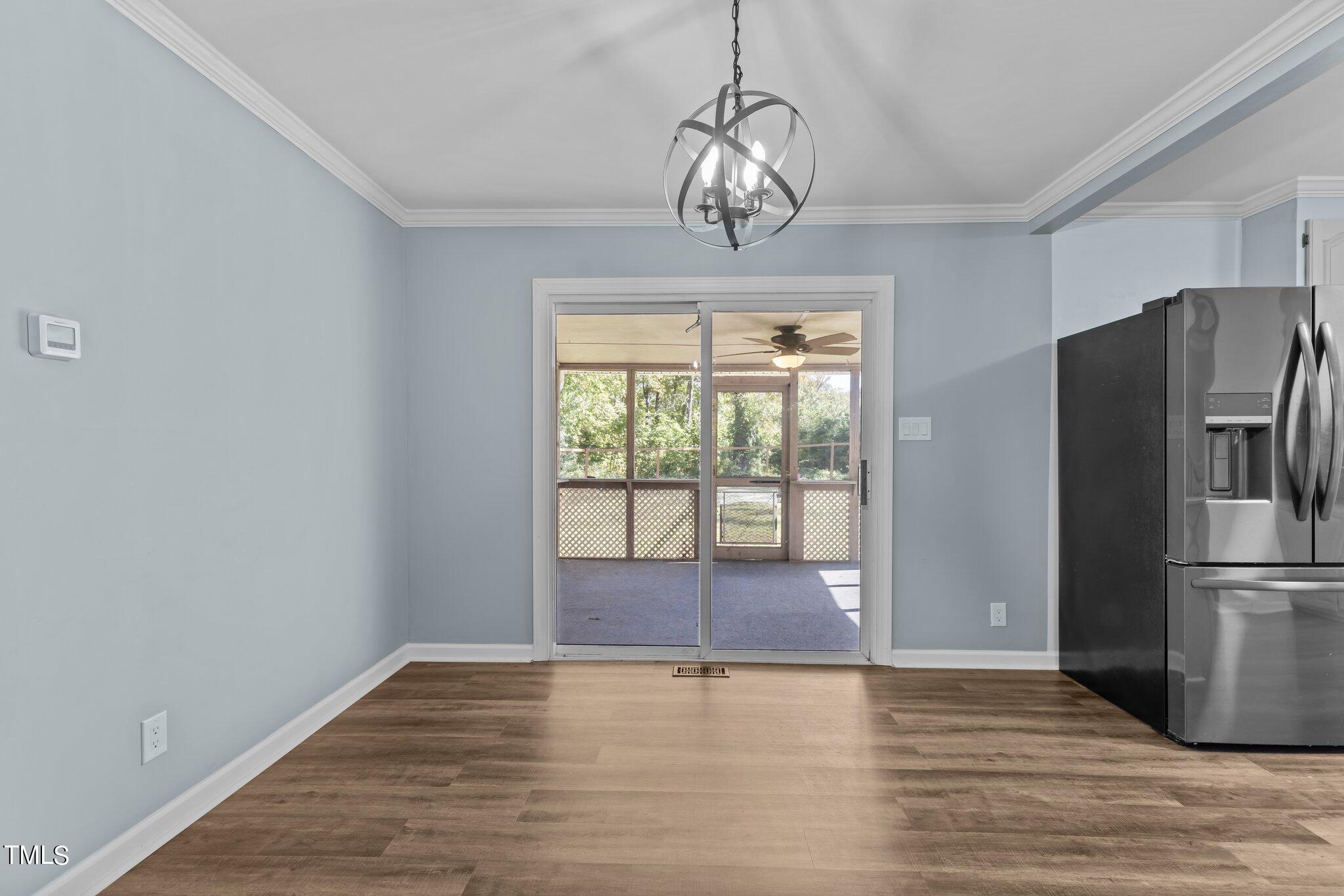 1224 Hedrick Drive Henderson, NC 27537 - Photo 12 of 32 a view of empty room with wooden floor and fan