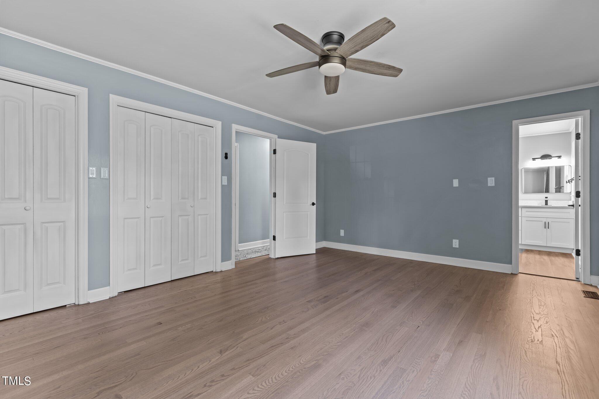1224 Hedrick Drive Henderson, NC 27537 - Photo 19 of 32 an empty room with wooden floor and windows
