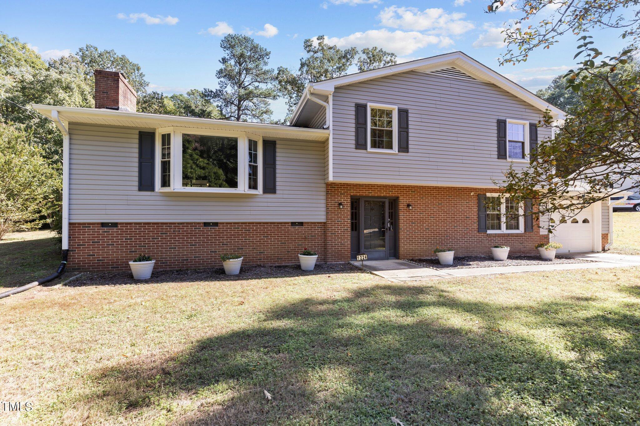 1224 Hedrick Drive Henderson, NC 27537 - Photo 3 of 32 a front view of a house with a yard
