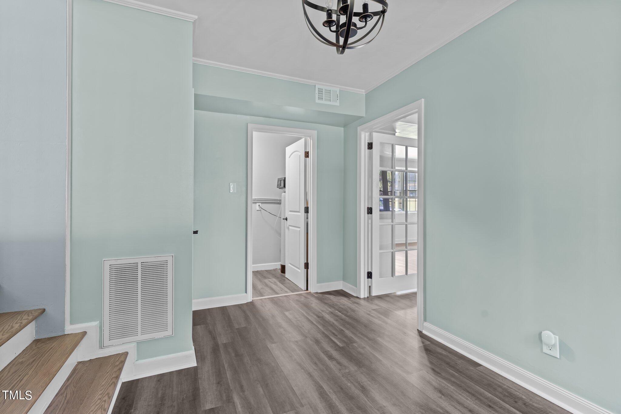 1224 Hedrick Drive Henderson, NC 27537 - Photo 5 of 32 an empty room with wooden floor and windows