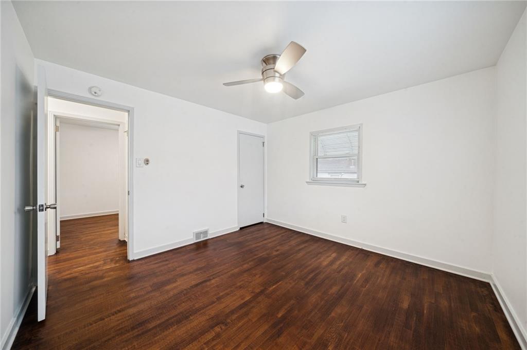 253 Stewart Street Elizabeth, PA 15037 - Photo 14 of 23 an empty room with wooden floor ceiling fan and windows