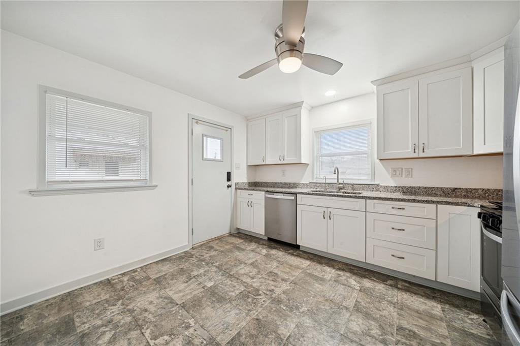 253 Stewart Street Elizabeth, PA 15037 - Photo 7 of 23 a kitchen with granite countertop white cabinets white stainless steel appliances with a sink and dishwasher