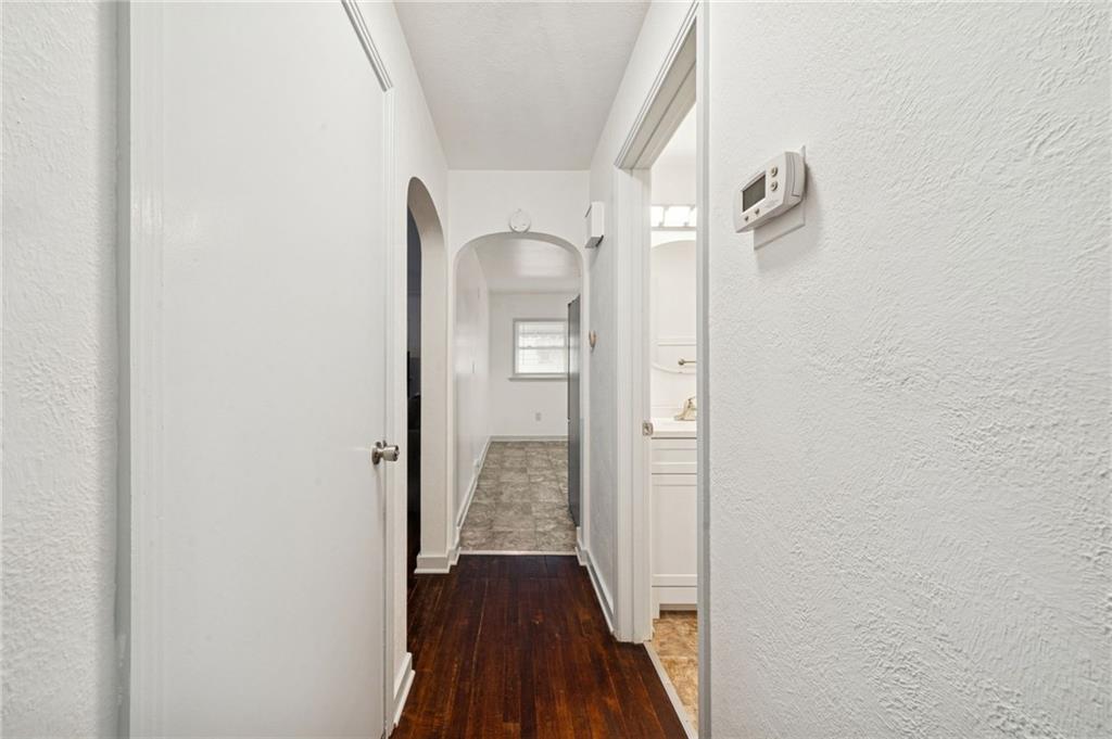 253 Stewart Street Elizabeth, PA 15037 - Photo 10 of 23 a view of a hallway with wooden floor and a bathroom