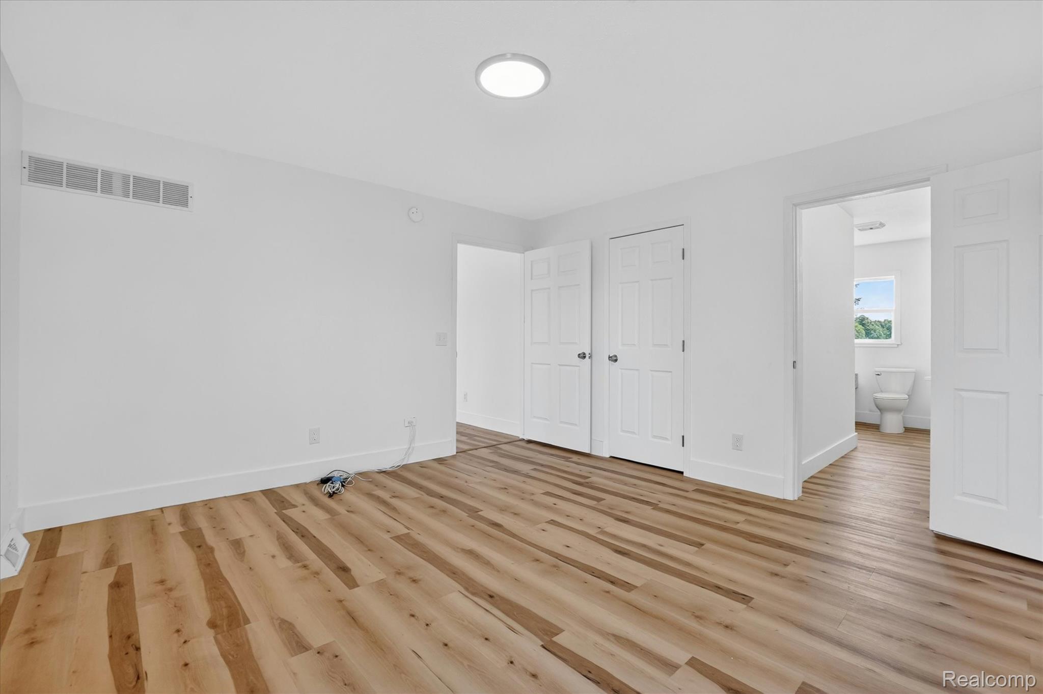 1400 North Every Road Mason, MI 48854 - Photo 10 of 33 Room featuring wood-finish flooring, white walls, and a recessed ceiling light