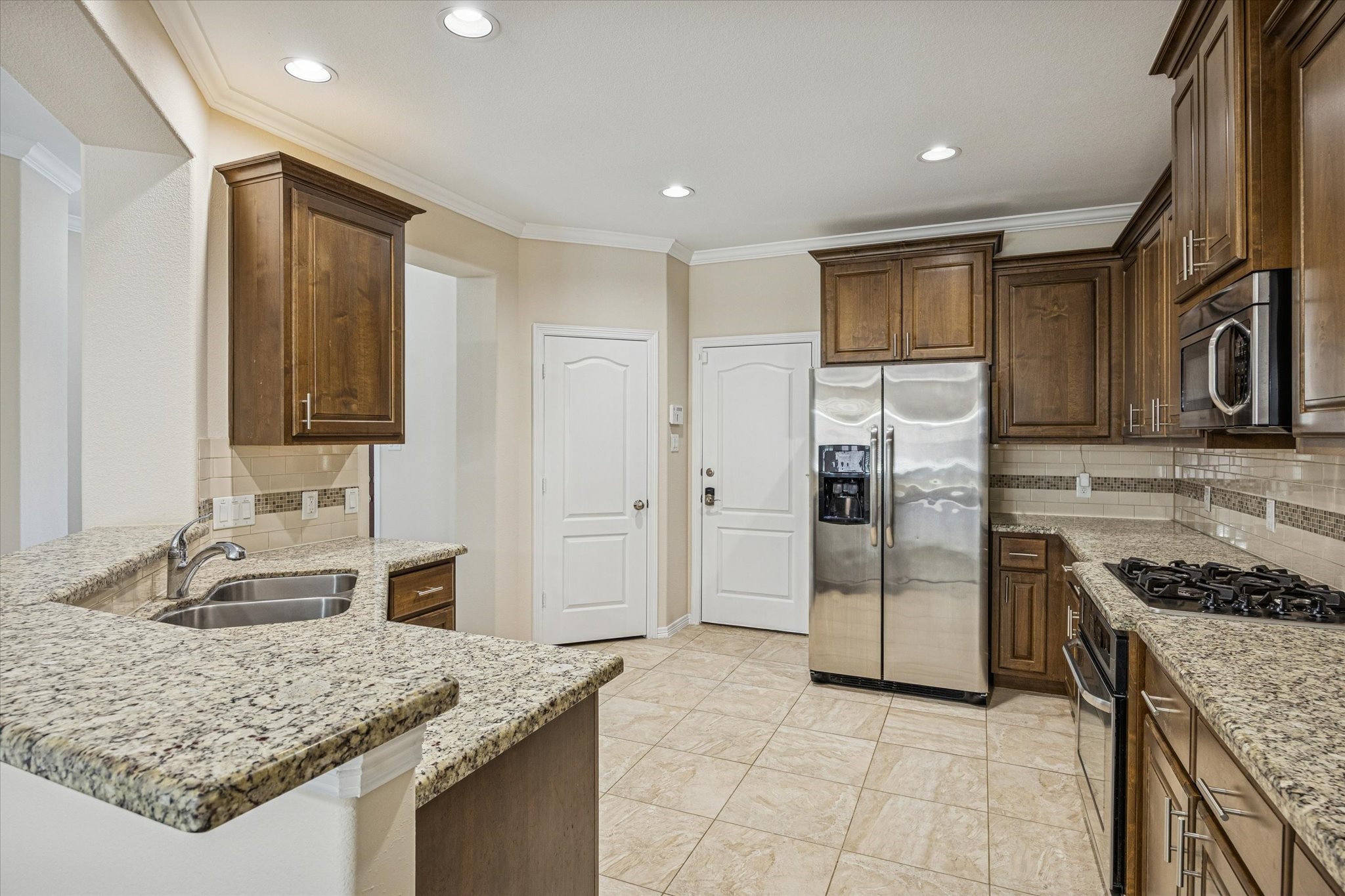 1113 Peden Street, Unit B Houston, TX 77006 - Photo 4 of 19 a kitchen with stainless steel appliances granite countertop a sink stove and refrigerator