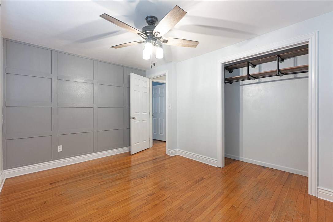 5235 West Ridgewood Road Springfield, OH 45503 - Photo 18 of 32 This spacious bedroom features wood flooring, a ceiling fan, and ample closet space.